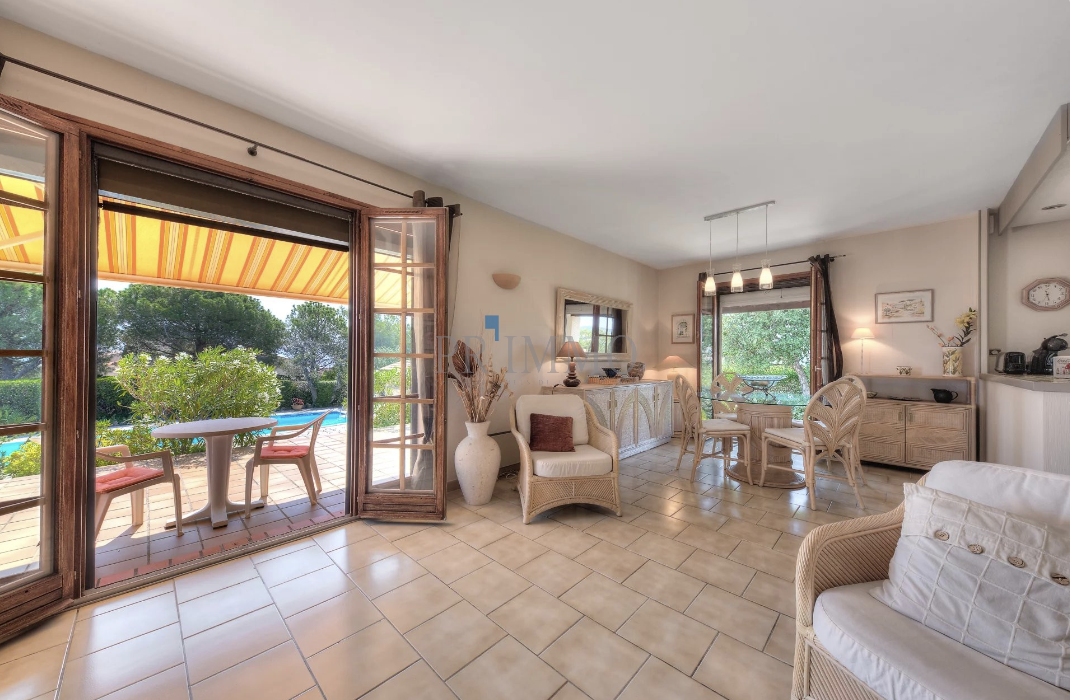 Interior of a single-storey villa with sea view, bright living room and garden