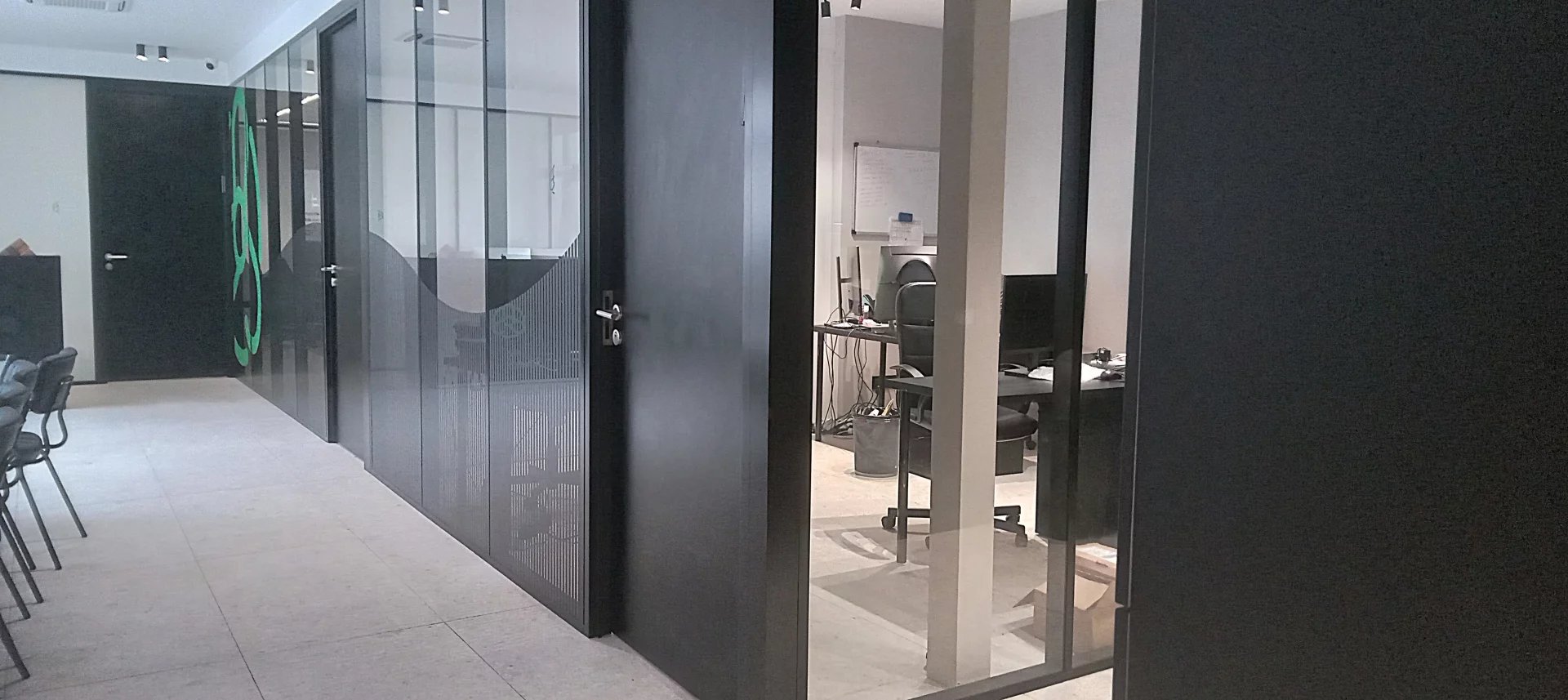 Interior of an office building complex Interior of an office building complex with glass partitions and workspaces.