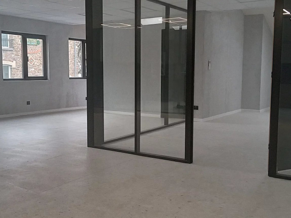 Interior of an office building complex in Choisy-le-Roi, with open spaces and glass partitions.