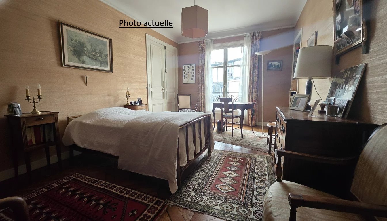 Chambre d’appartement Paris 17ème Chambre d'un appartement à Paris 17ème avec lit, meubles en bois et tapis au sol.