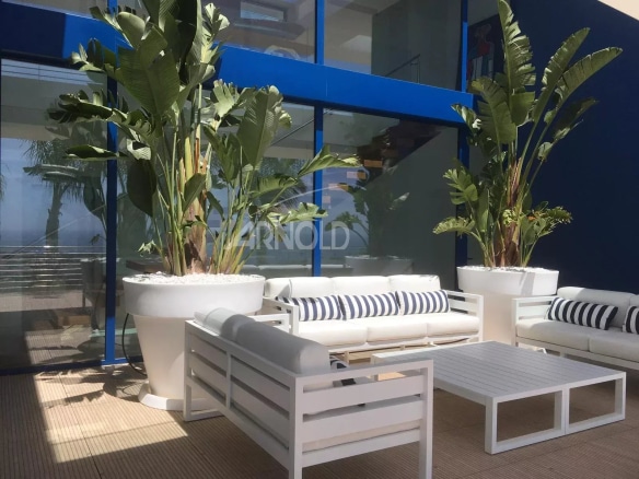 Modern terrace with white furniture and plants, overlooking the sea in Calpe.