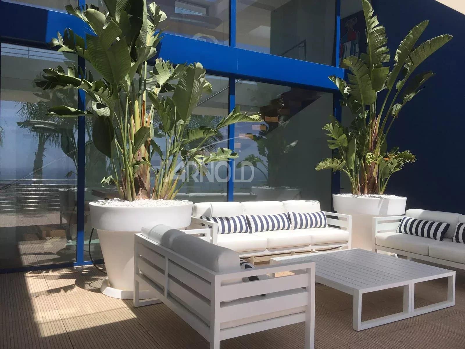 Modern terrace with white furniture and plants, overlooking the sea in Calpe.