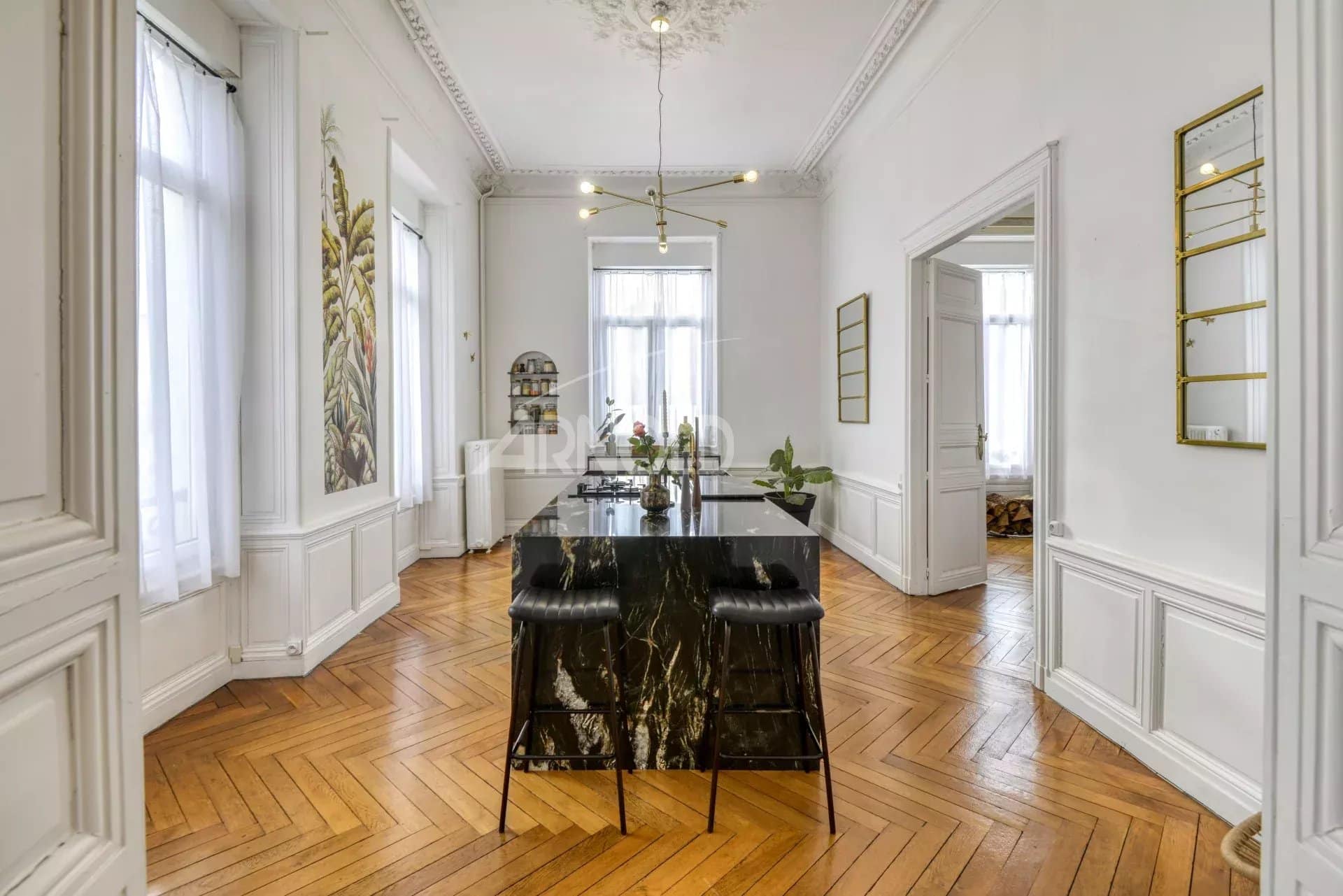 Interior of a private mansion in Ancenis with a marble counter and wooden parquet flooring