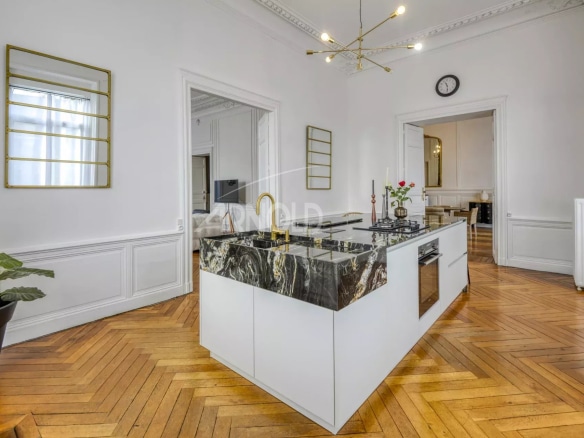 Modern kitchen with central marble island in a renovated private mansion in Ancenis-Saint-Géréon.