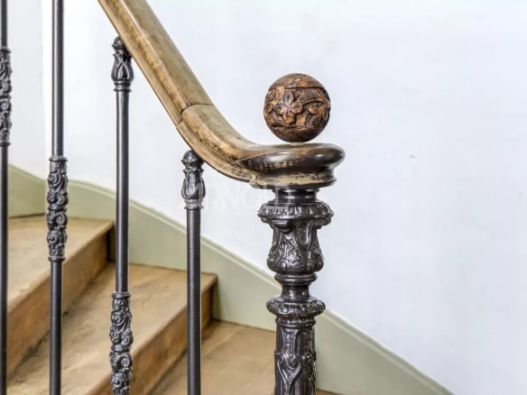 Wrought iron stair railing with wooden balusters in a private mansion in Ancenis