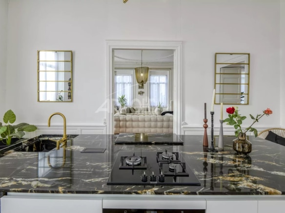 Modern kitchen with central marble island and contemporary decor in a private mansion in Ancenis.