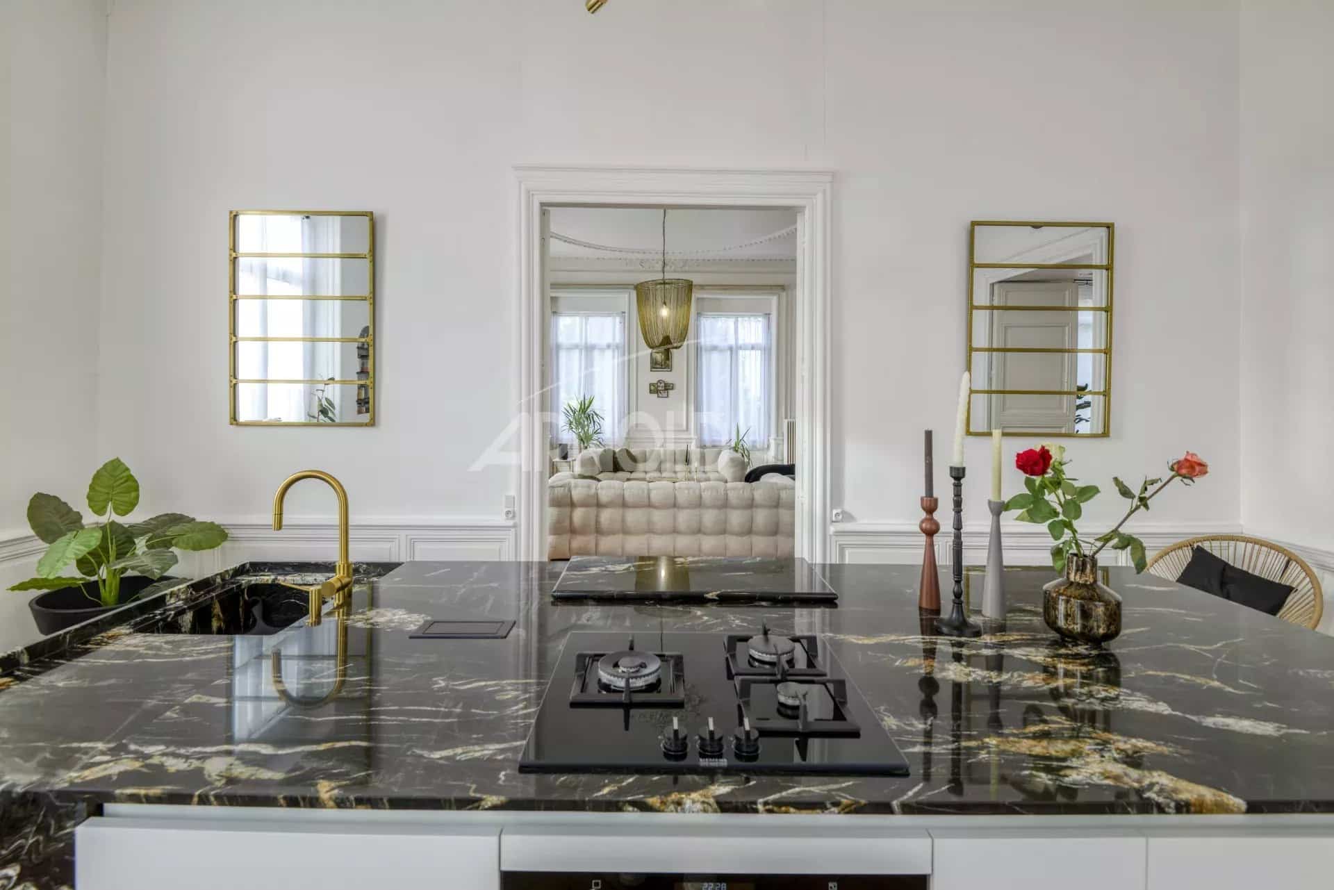 Modern kitchen with central marble island and contemporary decor in a private mansion in Ancenis.