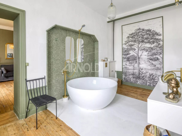 Modern bathroom with white bathtub and contemporary decor.