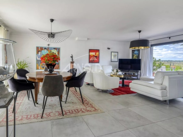 Interior of a renovated house with views of nature, modern living room and dining room.