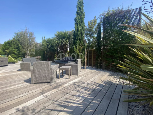 Wooden terrace with rattan furniture in a contemporary villa in Pornichet.
