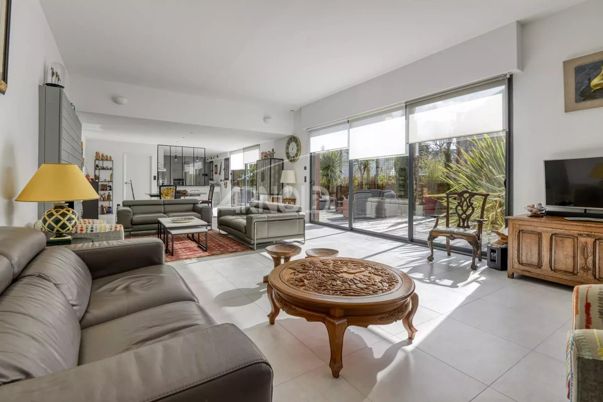 Interior of a contemporary villa in Pornichet with a spacious living room and large bay windows.
