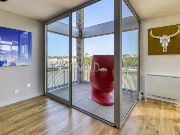 Interior of a duplex with bay windows and a view of the Loire in Nantes.