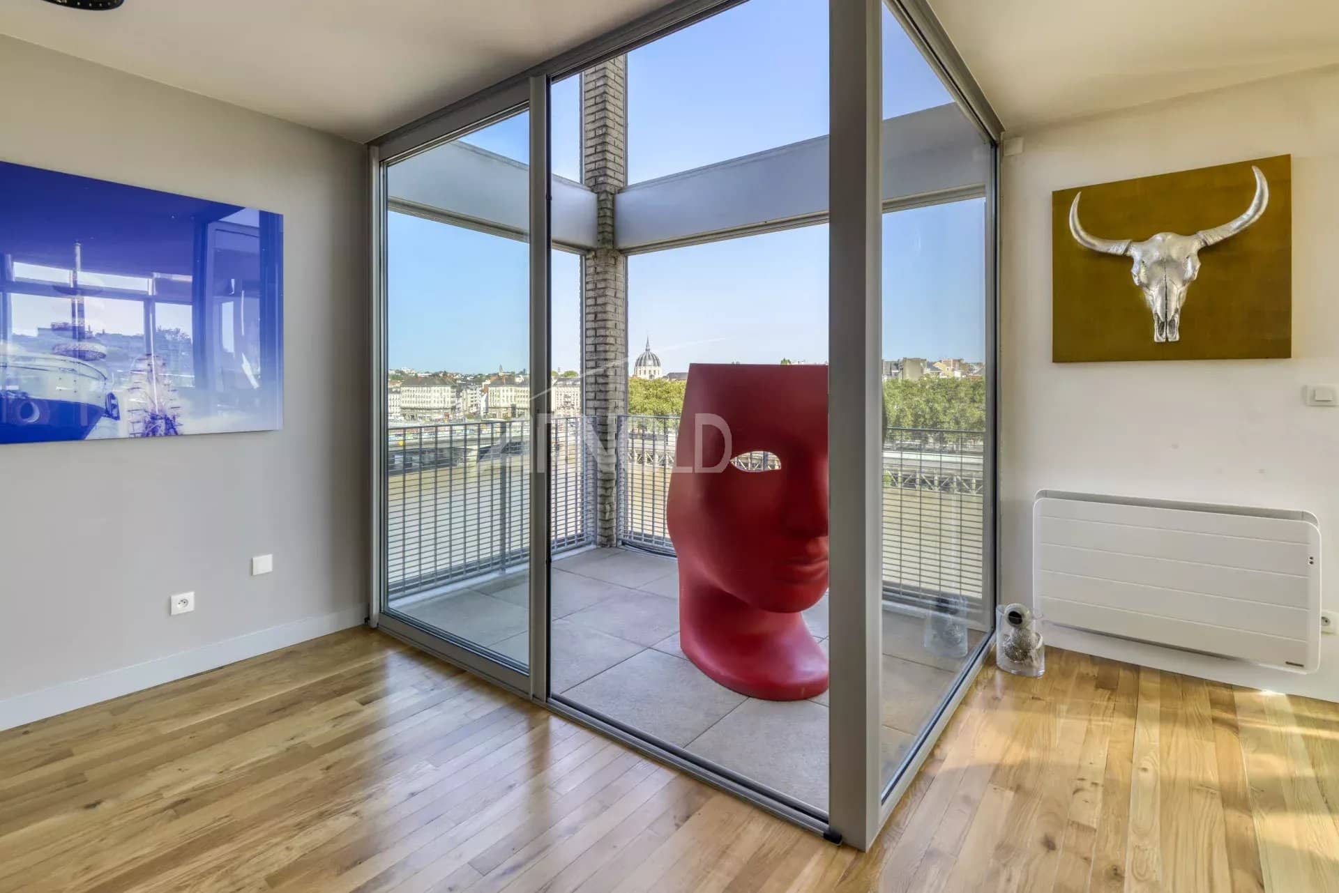Interior of a duplex with bay windows and a view of the Loire in Nantes.