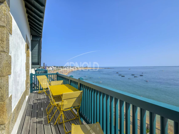 Terrasse d'un appartement avec vue sur l'océan à Batz-sur-Mer, chaises jaunes sur le balcon.
