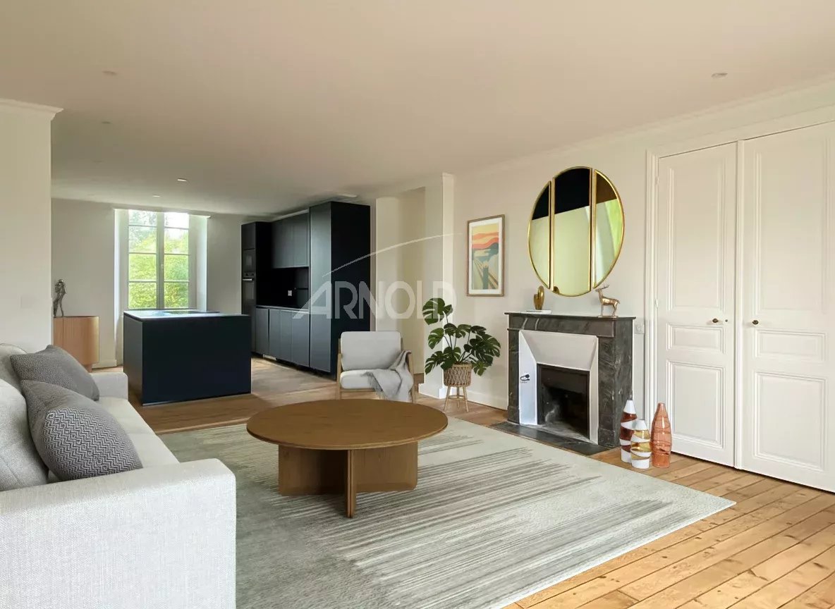 Interior of a renovated 4-room apartment with a bright living room and open kitchen in Vannes.
