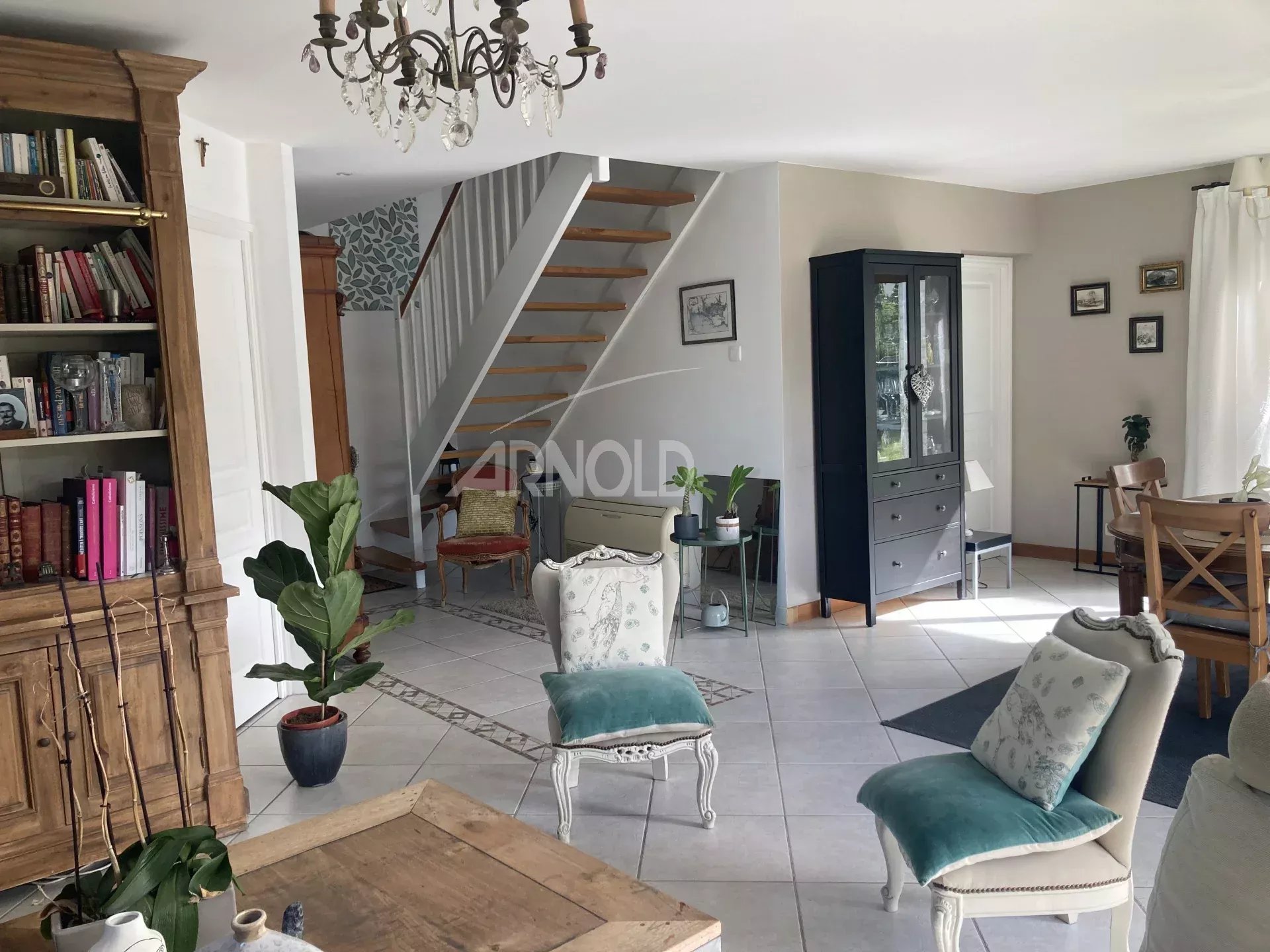 Interior of a family home in Vannes Interior of a family home in Vannes with a bright living room and a wooden staircase.