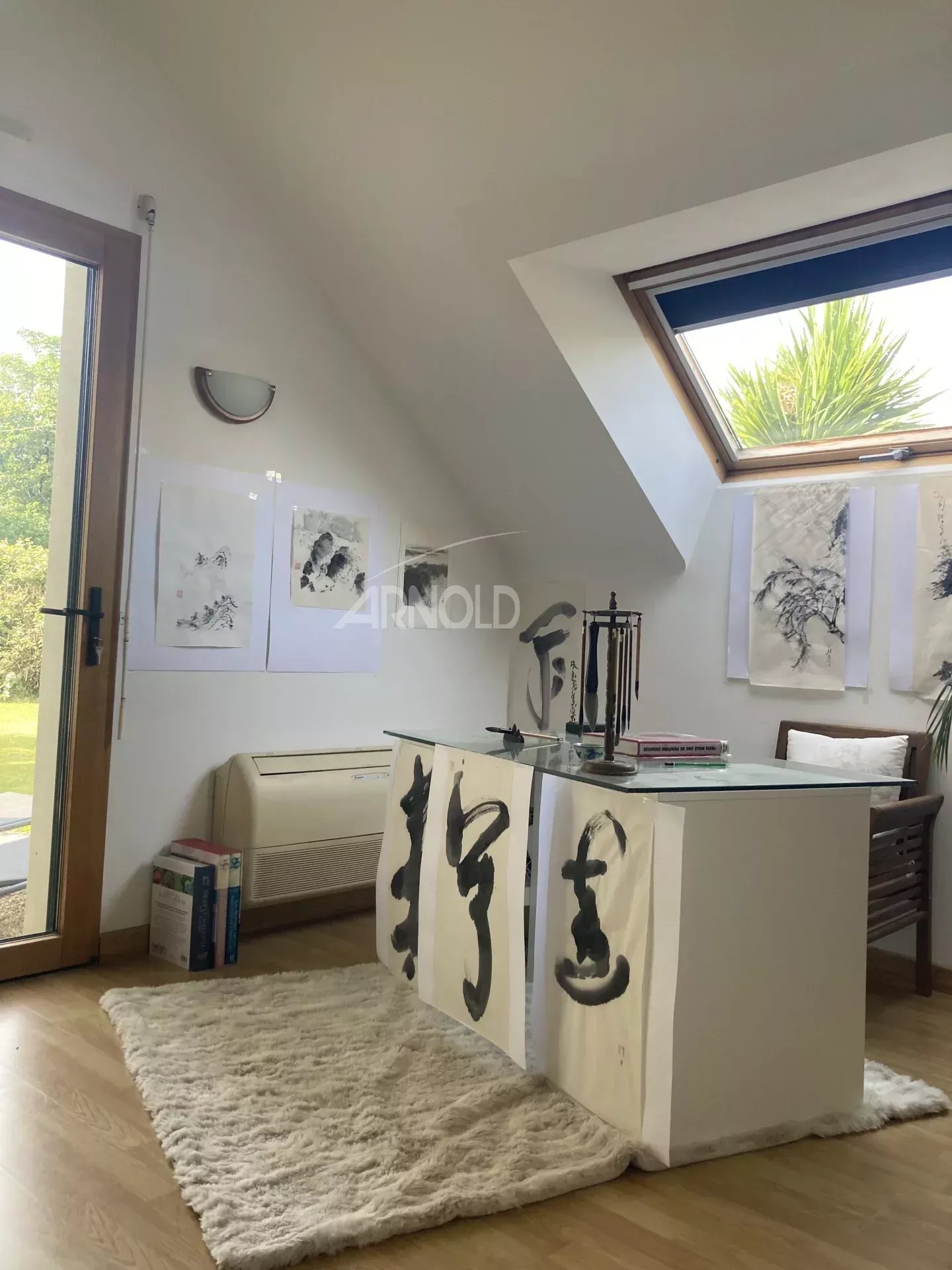 Bright office in a house in Vannes Interior of a house with a bright office and artwork hanging on the wall.