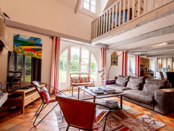 Interior of a stone farmhouse with a spacious living room and garden view.