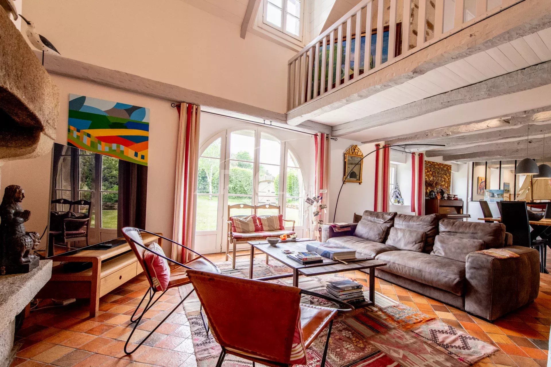 Interior of a longhouse in Baden Interior of a stone farmhouse with a spacious living room and garden view.