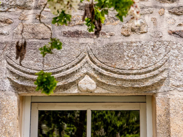Architectural stone detail above a window of a longhouse in Baden.