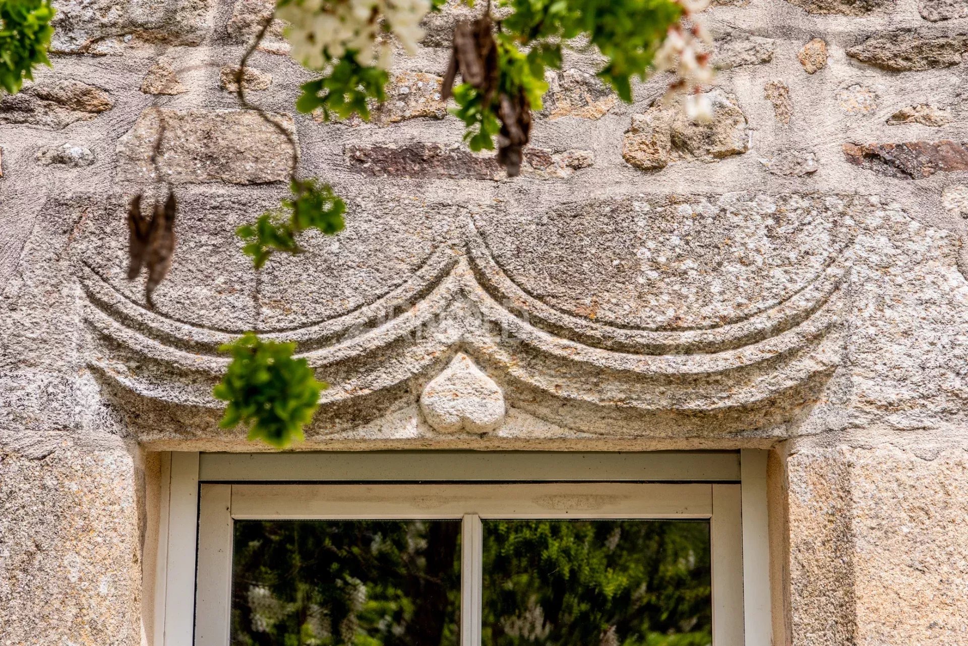 Detail of a stone farmhouse Architectural stone detail above a window of a longhouse in Baden.