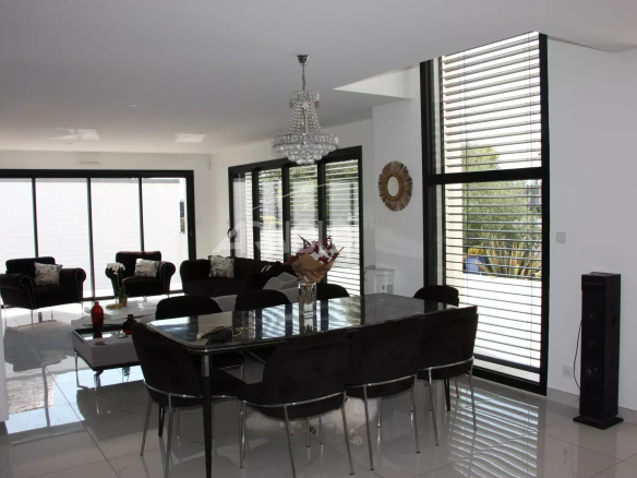 Interior of a contemporary villa with a bright living and dining area.