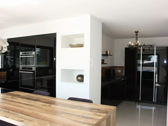 Modern interior of a contemporary villa with open kitchen and dining room.