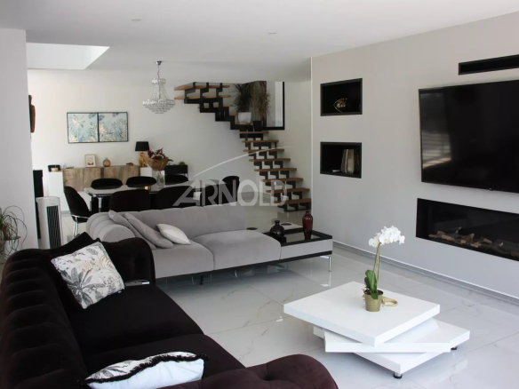 Interior of a contemporary villa in Vannes with a modern living room and fireplace.