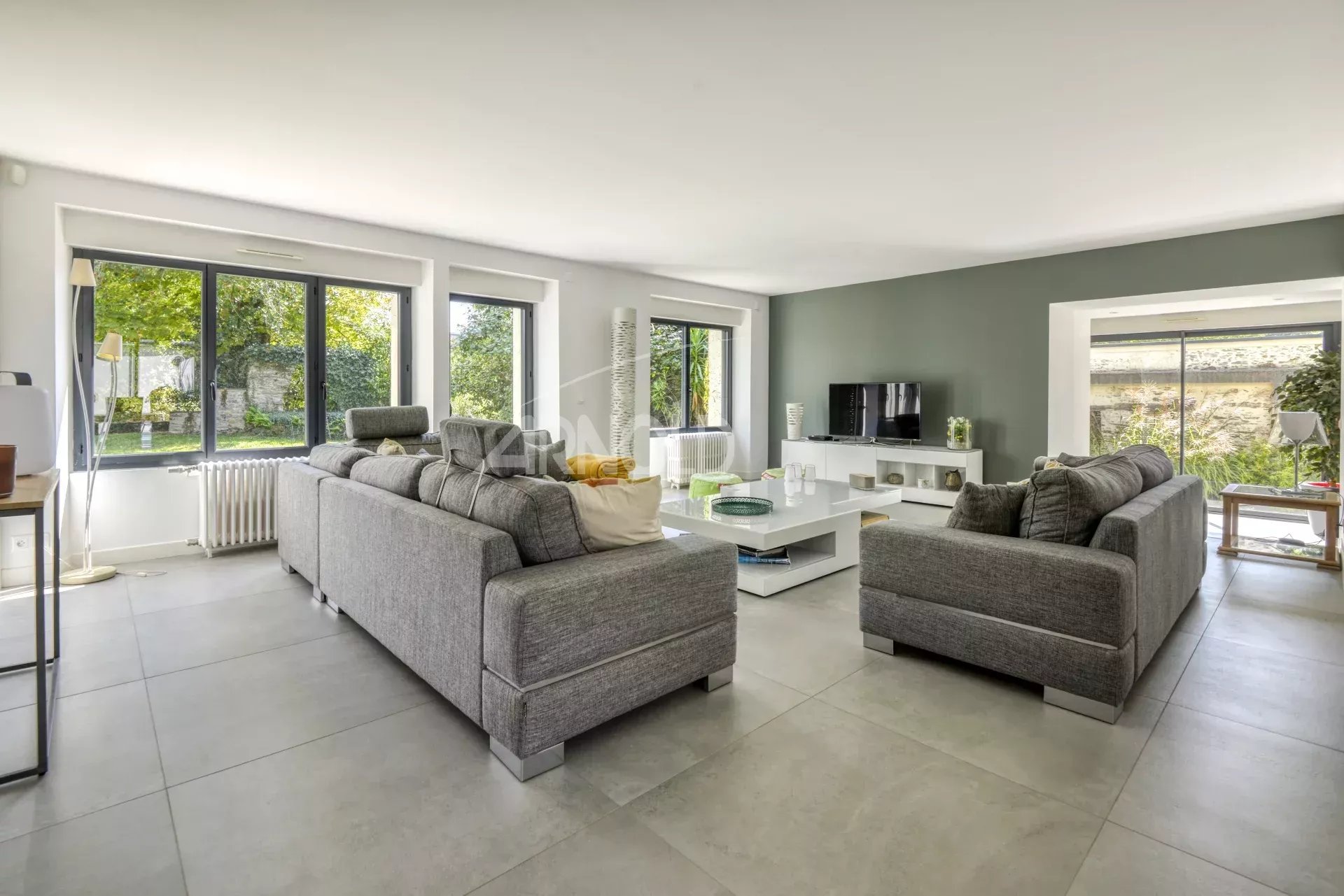 Living room of a house in Nantes Interior of a modern home with a bright living room and large windows.