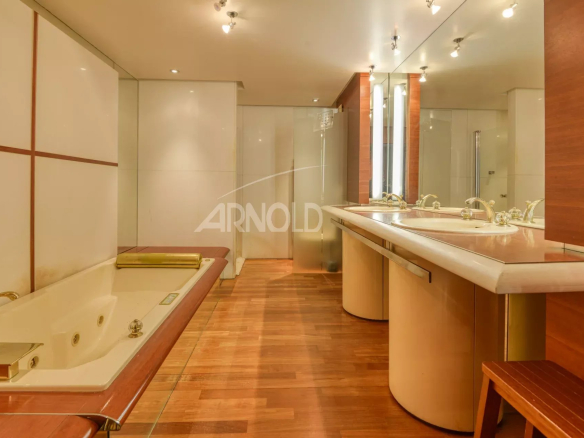 Modern bathroom with bathtub and double sink in a luxury apartment.