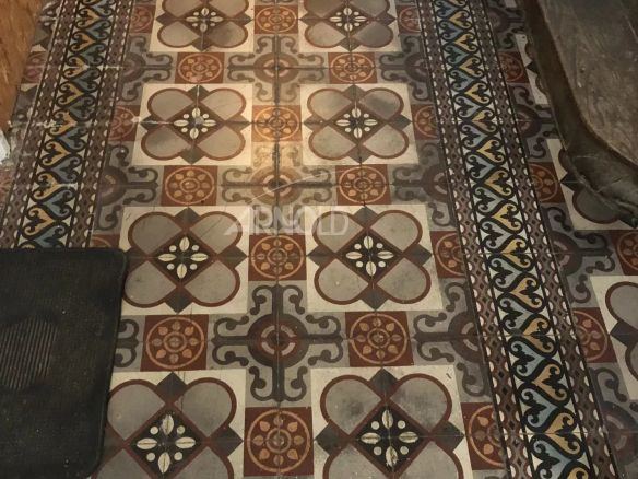 Old tiles in a house to be renovated in Vannes, showing colorful patterns.