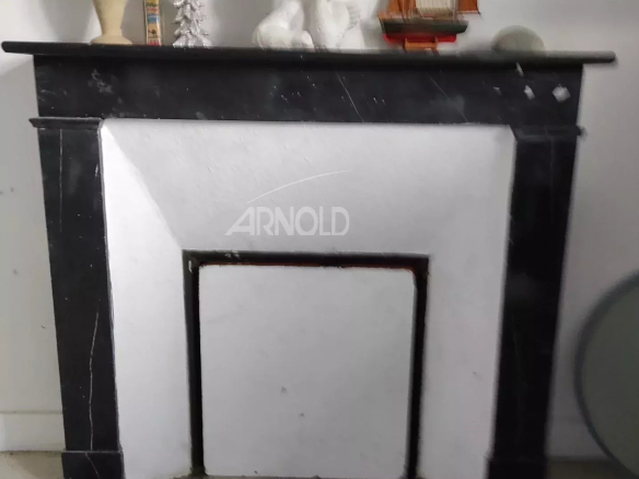 Black marble fireplace in a house to be renovated in Vannes.