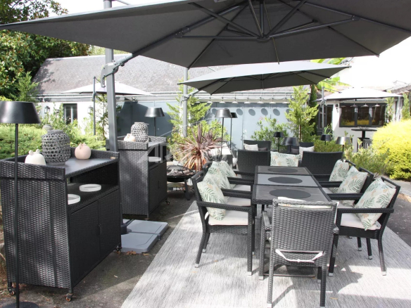 Terrace furnished with garden furniture in a house in Belz.
