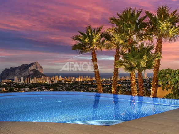 Modern villa with infinity pool and sea view in Calpe, Spain, at sunset.