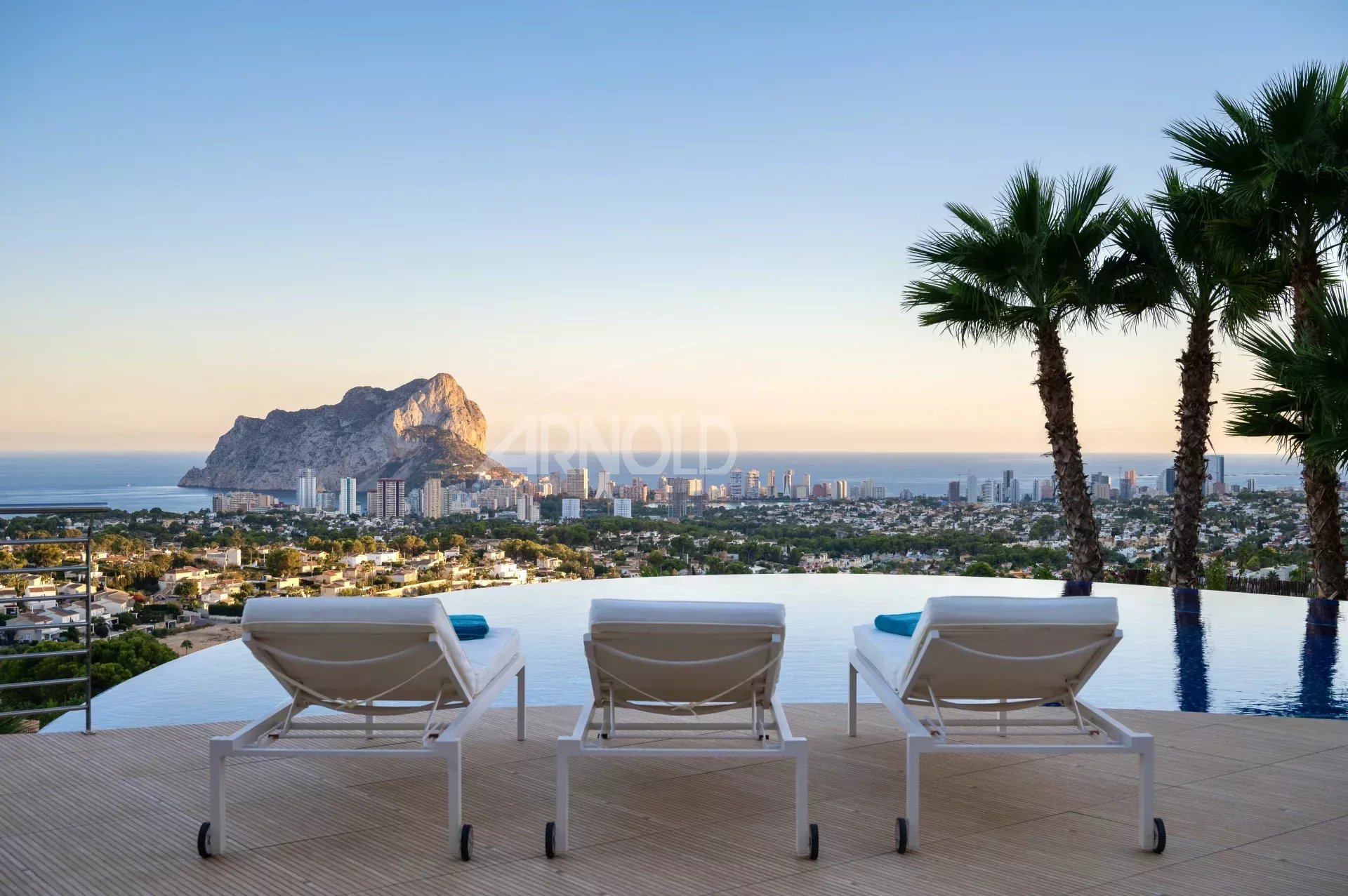 View of the pool and sun loungers with the Penyal d'Ifac in the background in Calpe, Alicante.