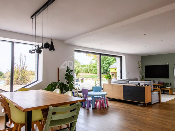 Interior of a contemporary farmhouse with dining room and pool view