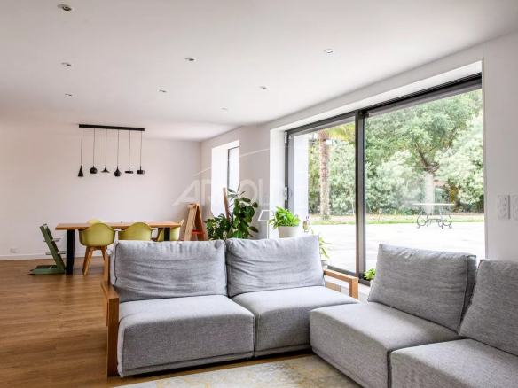 Interior of a contemporary farmhouse with a bright living room and dining area.