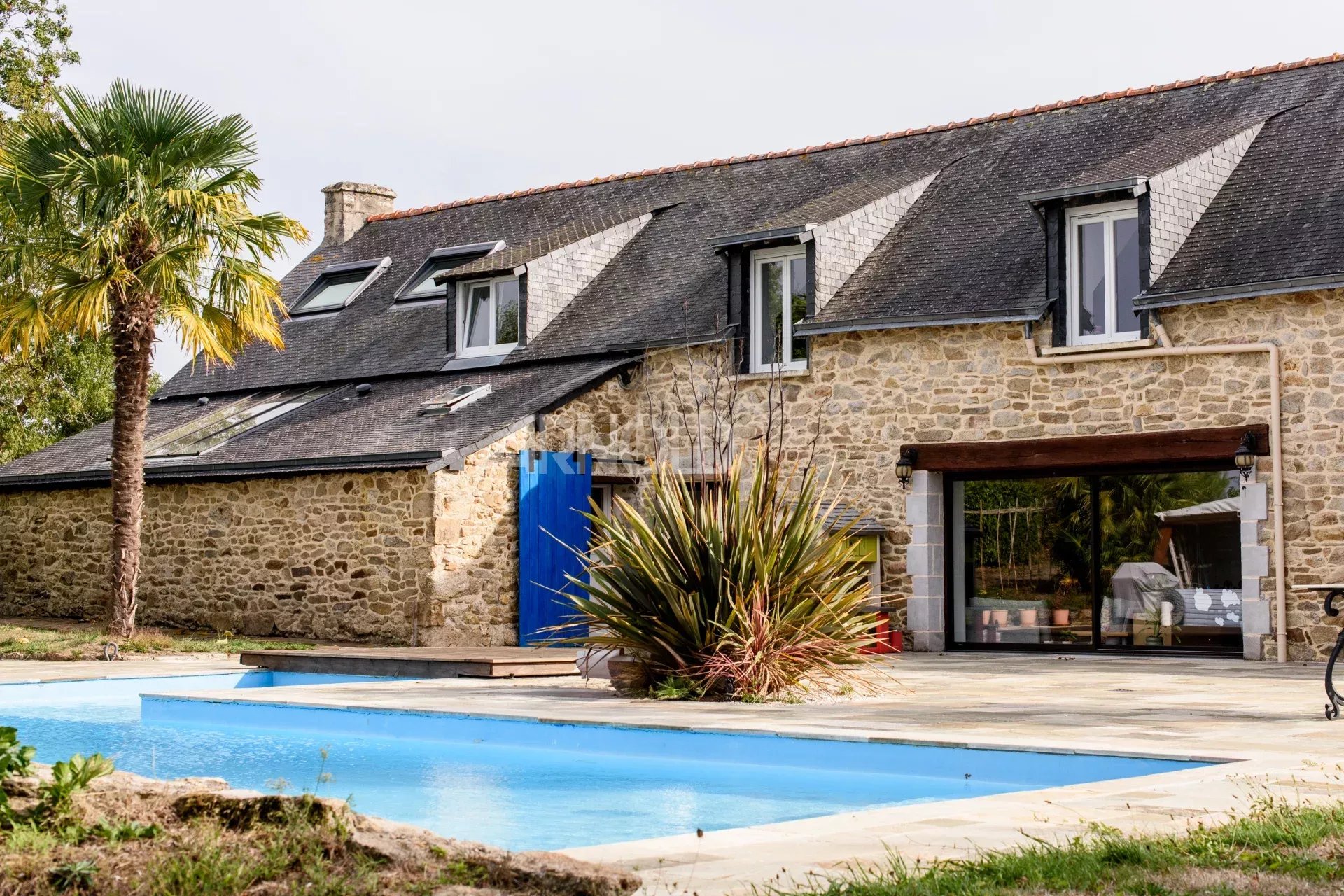 Contemporary farmhouse with swimming pool Contemporary stone farmhouse with swimming pool and landscaped garden in Surzur.