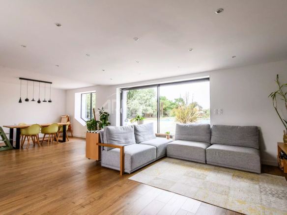 Interior of a contemporary farmhouse with a spacious living room and garden view.