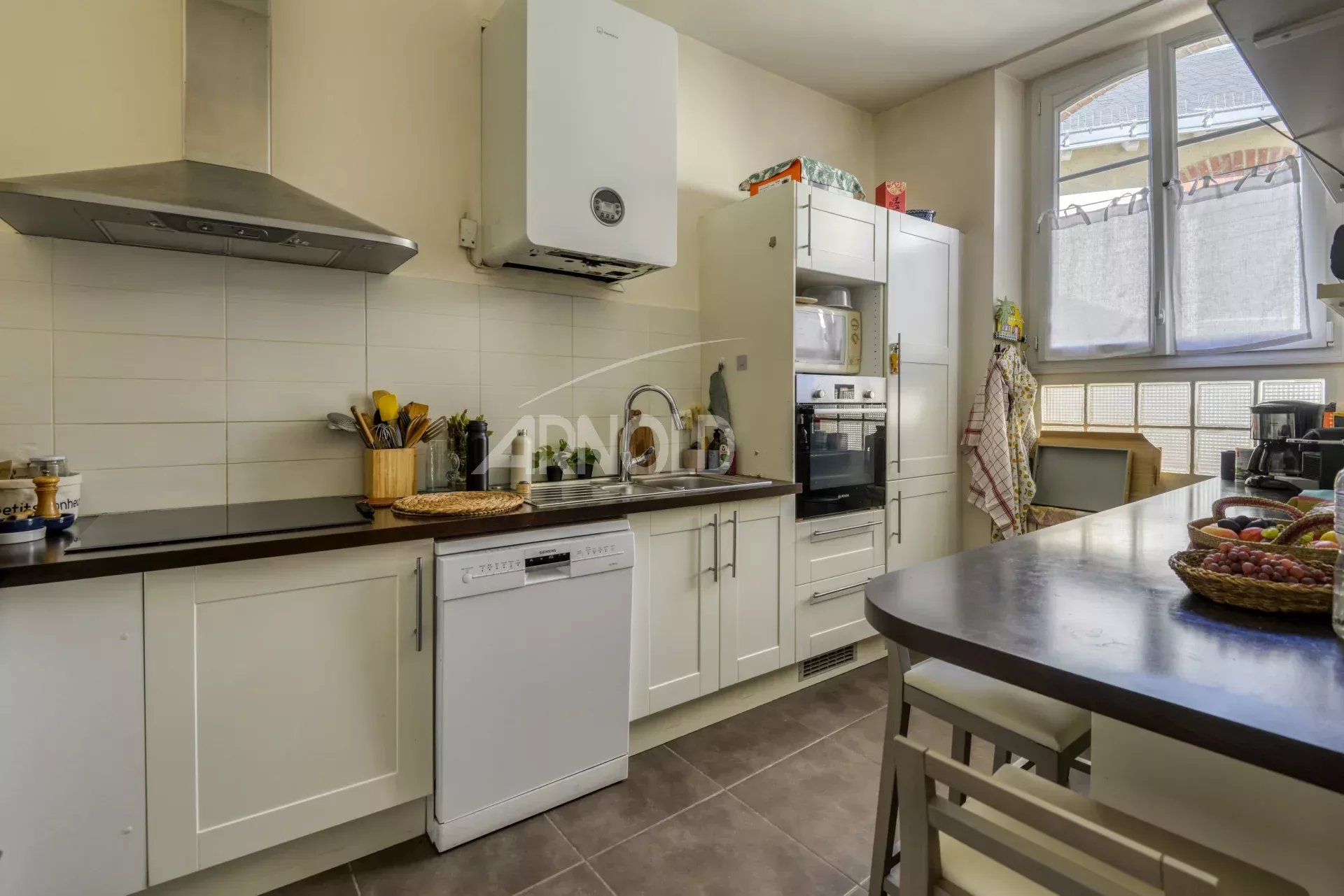 Kitchen of a 6-room apartment in Nantes Modern fitted kitchen in a 6-room apartment in Nantes, with worktops and appliances.