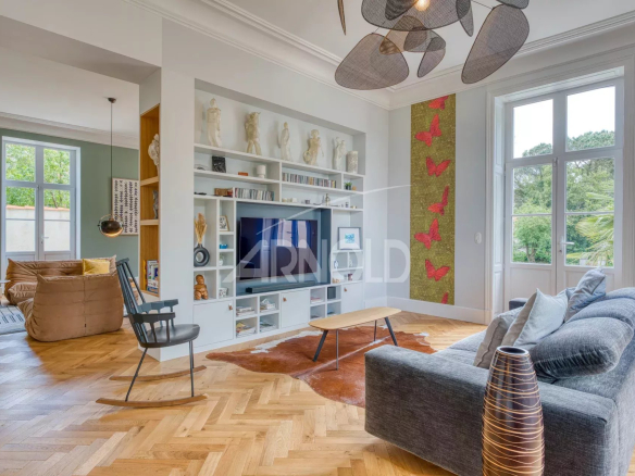 Modern interior of a living room with sofa, television and elegant decor in an 18th century property.