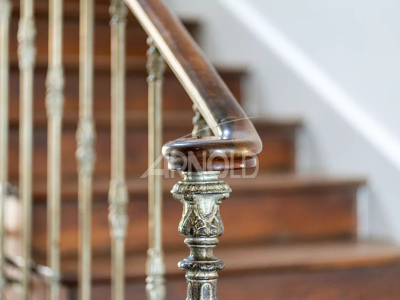 Metal and wood railing of a staircase in an 18th century priory.