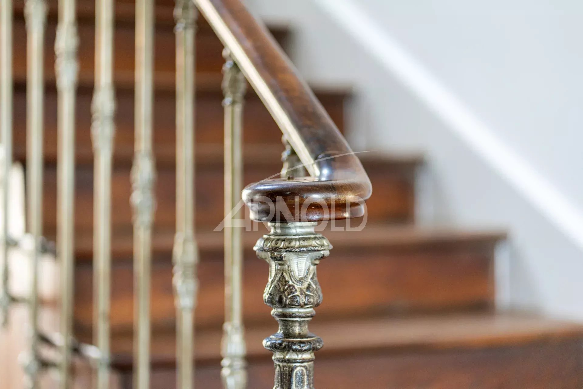 Metal and wood railing of a staircase in an 18th century priory.