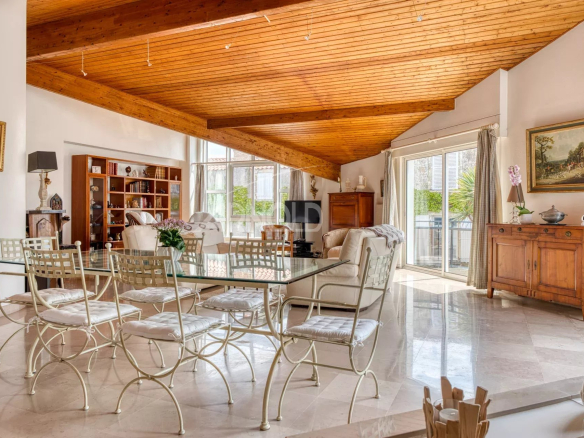 Interior of a house with a bright living space and a wooden ceiling, living room and dining room.