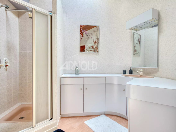 Modern bathroom with shower, sink and mirror in a house.