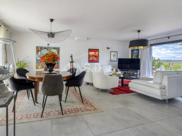 Interior of a renovated house with living room, dining room and view of nature.