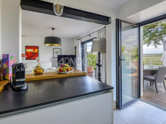 Interior of a renovated house with views of nature, bright living room and dining area.
