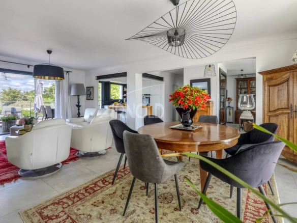 Interior of a renovated house with living room, dining room and modern decor in Le Pouliguen.
