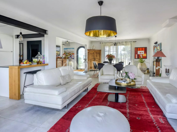 Interior of a renovated house with living room, dining room and open kitchen, modern and bright decor.