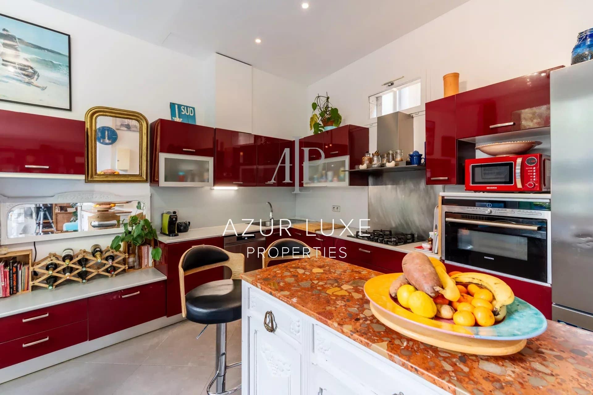 Kitchen of Villa Mireille in Nice Modern kitchen with red furniture and a marble worktop, bright and spacious.
